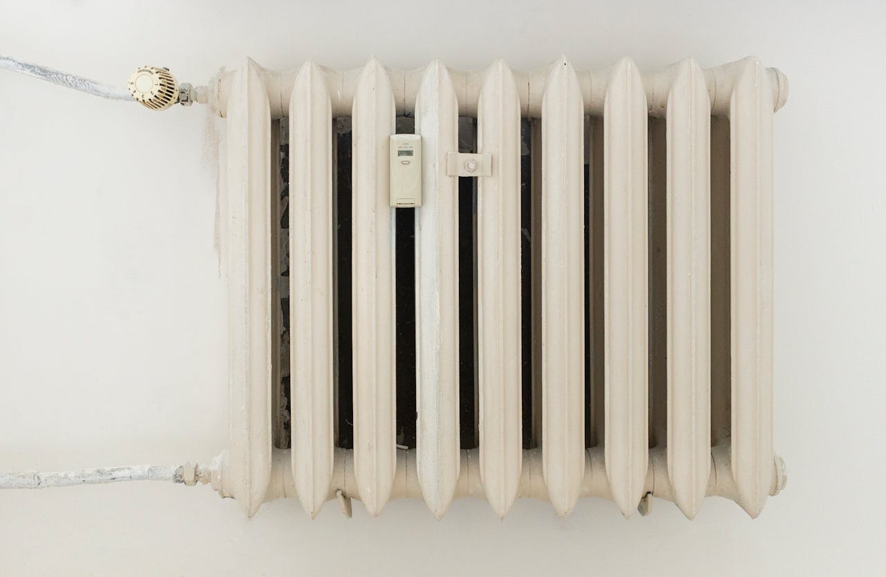 white steel rib radiator in a new bright renovated room in apartment or home 12034871